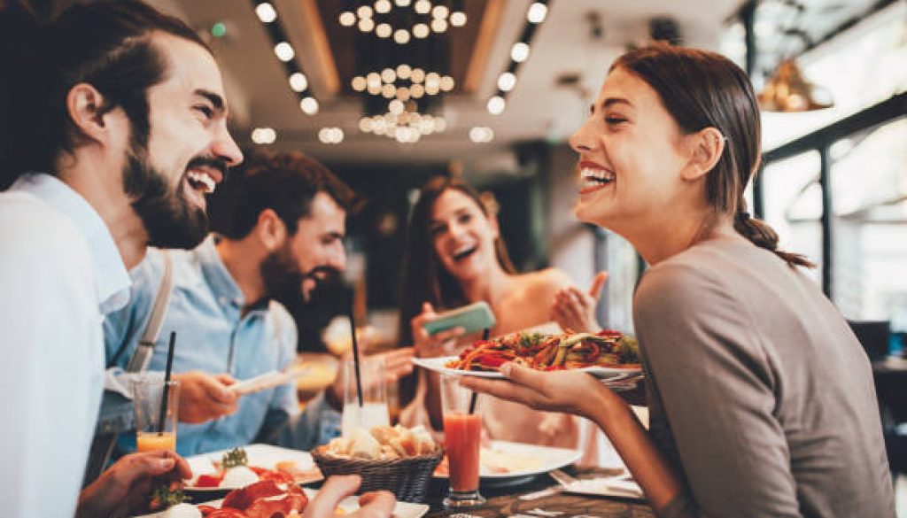 Group of Happy friends having breakfast in the restaurant